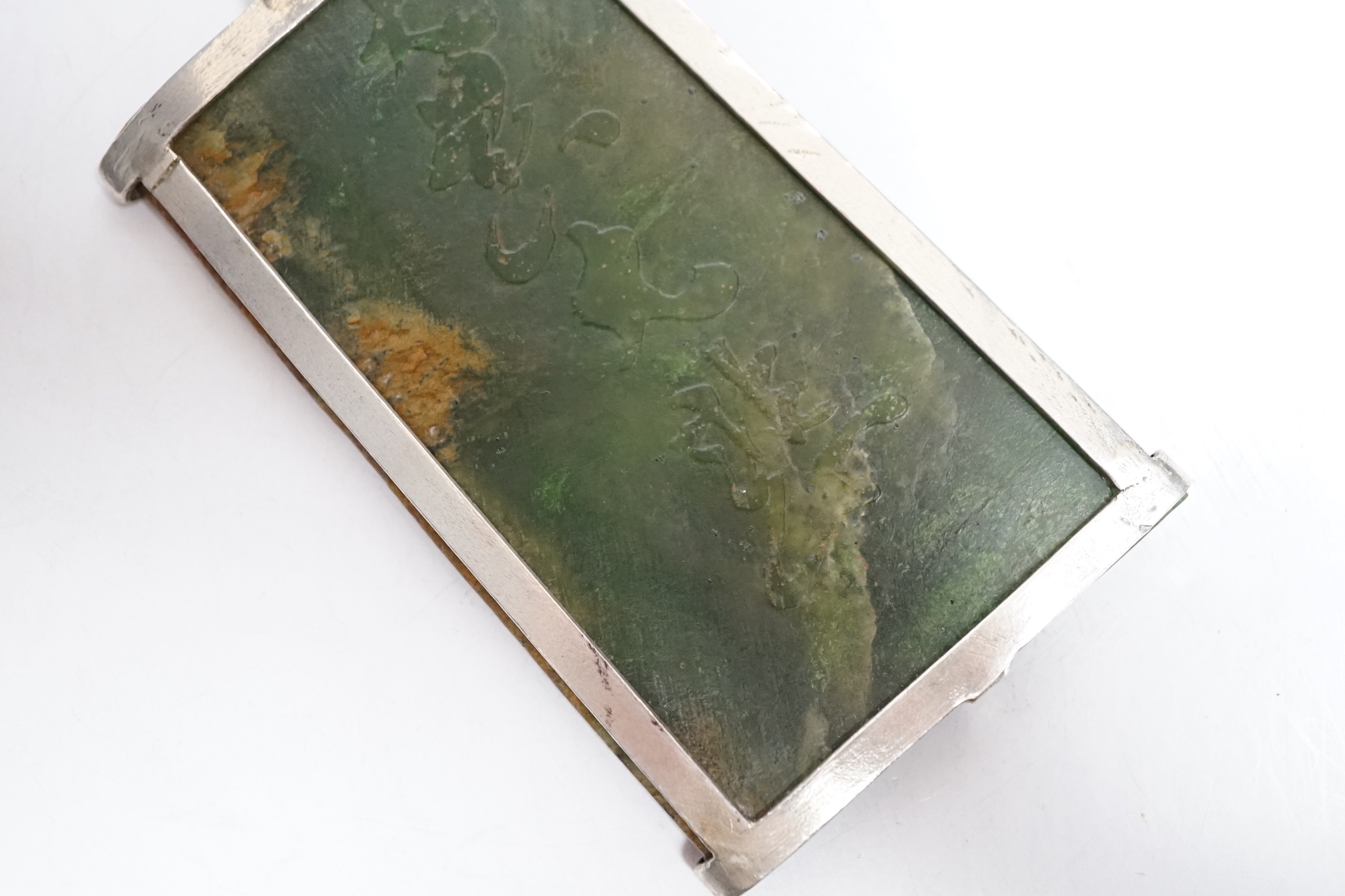 A Chinese carved spinach green jade panel, 9cms high.